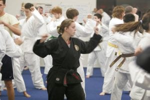 Martial Arts Studio With a woman in black and men in white