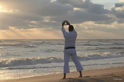 Sensei George Rego, FJJA Chief Instructor, practices the classical karate kata - Kanku (sky observation) during a 6am sunrise beach jujitsu & karate workout